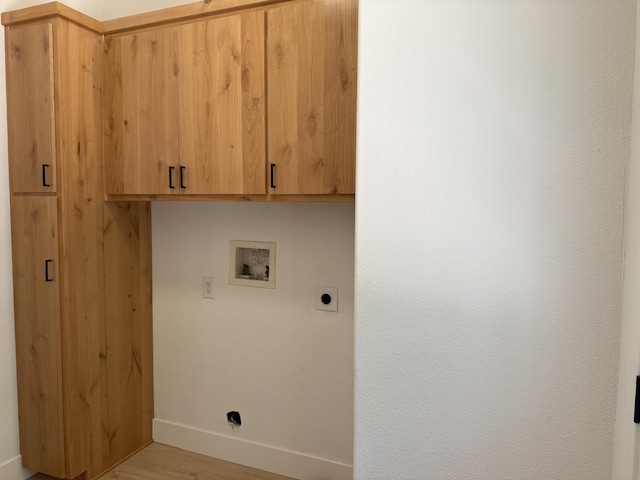 10360 Ritts Mill Rd, Shingletown, CA 96088 - washroom featuring hookup for an electric dryer, hookup for a washing machine, cabinet space, and light wood-type flooring