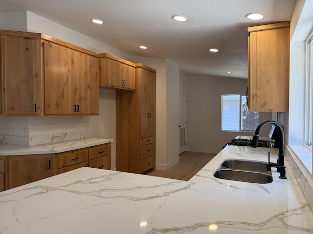10360 Ritts Mill Rd, Shingletown, CA 96088 - kitchen with light stone counters, recessed lighting, brown cabinets, and light wood finished floors