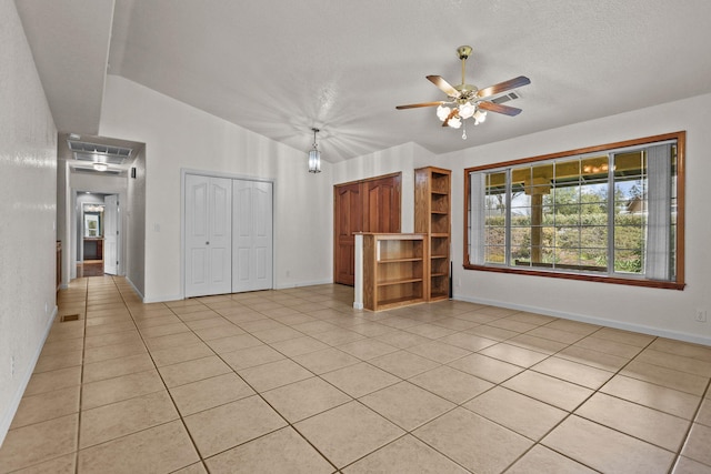 12526 Glide Way, Redding, CA 96003 - unfurnished living room featuring ceiling fan, light tile patterned flooring, healthy amount of natural light, a textured ceiling, and vaulted ceiling