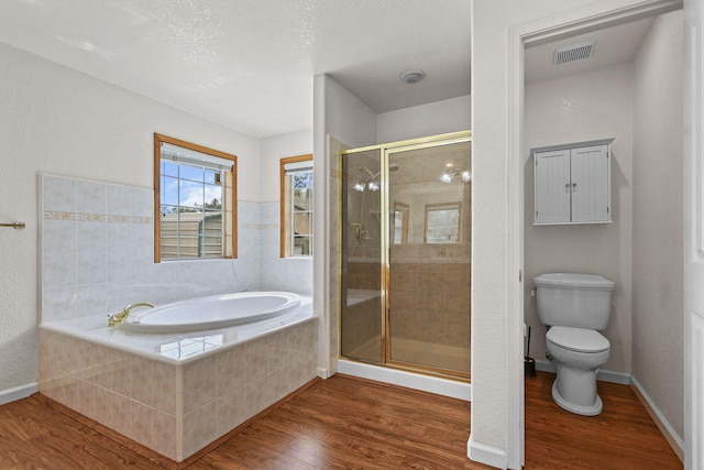 12526 Glide Way, Redding, CA 96003 - bathroom with a bath, wood finished floors, and a stall shower