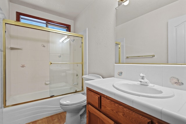 12526 Glide Way, Redding, CA 96003 - bathroom with vanity, wood finished floors, enclosed tub / shower combo, and a textured wall