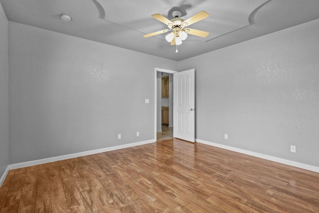 12526 Glide Way, Redding, CA 96003 - empty room with wood finished floors, ceiling fan, a smoke detector, and a textured wall