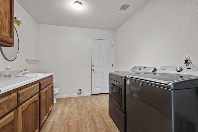 12526 Glide Way, Redding, CA 96003 - washroom with washing machine and clothes dryer and light wood finished floors