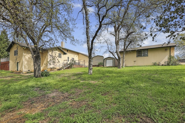 12526 Glide Way, Redding, CA 96003 - view of grassy yard featuring an outbuilding and a detached garage