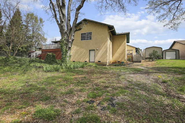 12526 Glide Way, Redding, CA 96003 - back of house with stucco siding, crawl space, stairway, a wooden deck, and an outbuilding