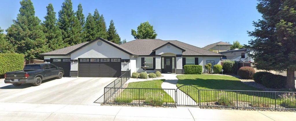 3258 Laver St, Redding, CA 96002 - ranch-style home with a fenced front yard, a garage, driveway, a gate, and stucco siding