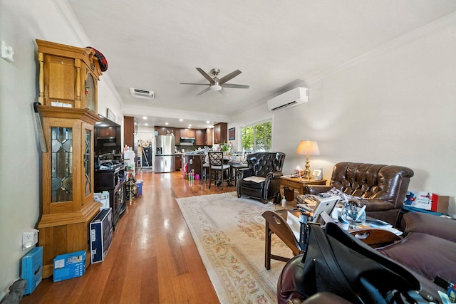 1635 Pleasant St, Redding, CA 96001 - living room with a ceiling fan, a wall mounted AC, crown molding, and light wood finished floors