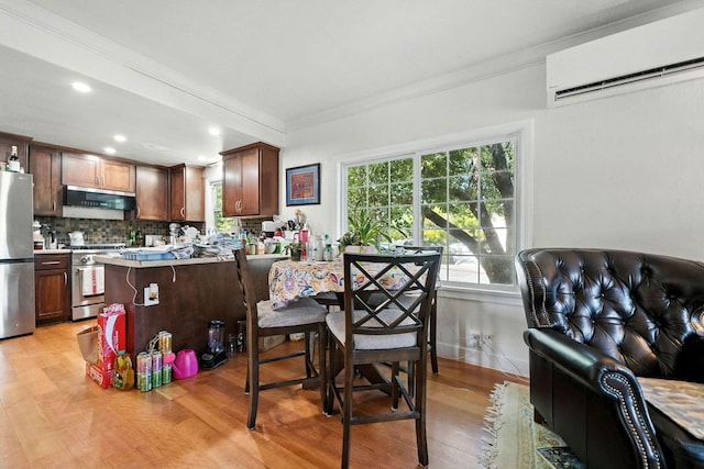 1635 Pleasant St, Redding, CA 96001 - kitchen featuring a wall unit AC, appliances with stainless steel finishes, crown molding, light wood finished floors, and tasteful backsplash