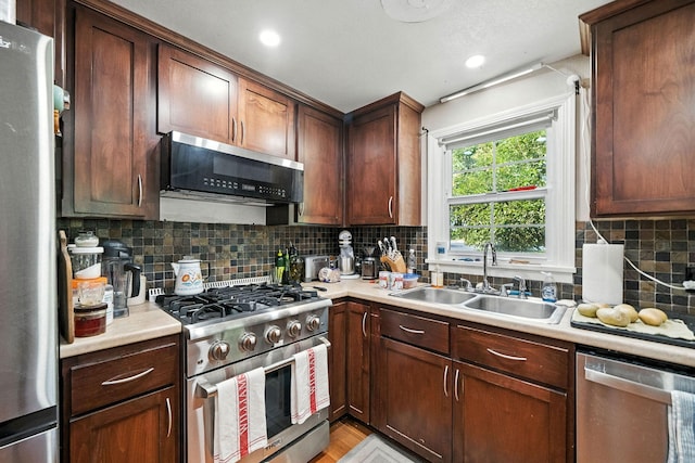 1635 Pleasant St, Redding, CA 96001 - kitchen with appliances with stainless steel finishes, light countertops, backsplash, light wood-style floors, and recessed lighting