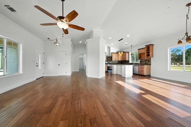 18435 Danielle Way, Cottonwood, CA 96022 - unfurnished living room featuring ceiling fan, arched walkways, dark wood-style flooring, crown molding, and vaulted ceiling