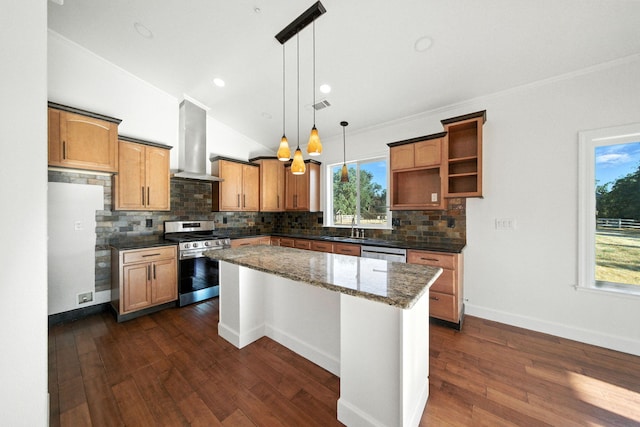 18435 Danielle Way, Cottonwood, CA 96022 - kitchen with appliances with stainless steel finishes, wall chimney range hood, backsplash, a kitchen island, and dark stone countertops