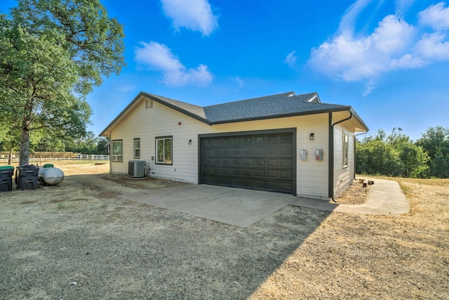 18435 Danielle Way, Cottonwood, CA 96022 - view of side of property featuring driveway, a garage, and roof with shingles