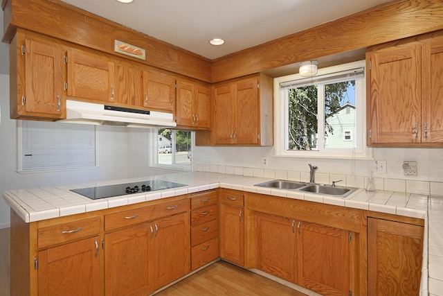 210 Sherman St, Yreka, CA 96097 - kitchen with black electric cooktop, under cabinet range hood, healthy amount of natural light, light wood-style flooring, and recessed lighting