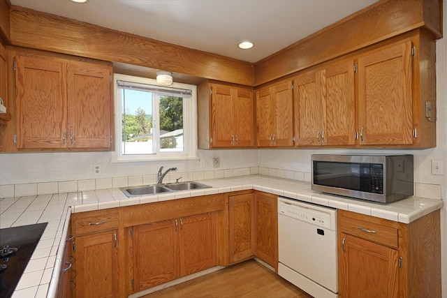 210 Sherman St, Yreka, CA 96097 - kitchen featuring dishwasher, stainless steel microwave, brown cabinetry, recessed lighting, and black electric cooktop