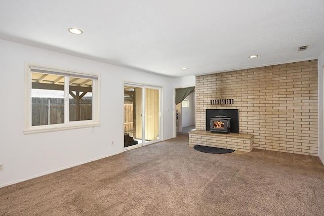 210 Sherman St, Yreka, CA 96097 - unfurnished living room with carpet floors, a wood stove, and recessed lighting