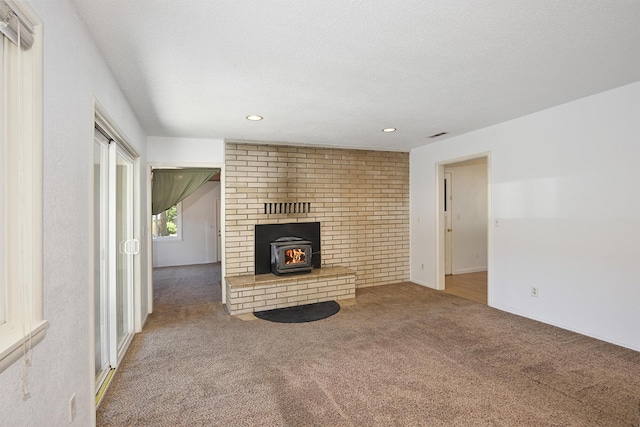 210 Sherman St, Yreka, CA 96097 - unfurnished living room with a wood stove, carpet flooring, recessed lighting, and a textured ceiling