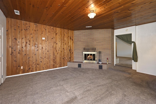 210 Sherman St, Yreka, CA 96097 - unfurnished living room with carpet floors, a brick fireplace, wood ceiling, and wood walls