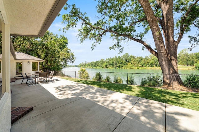 2949 Felstet Ln, Redding, CA 96001 - fenced backyard with a water view, a patio area, and outdoor dining area