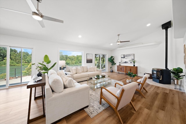 2949 Felstet Ln, Redding, CA 96001 - living room featuring a ceiling fan, a wood stove, light wood-type flooring, lofted ceiling, and recessed lighting