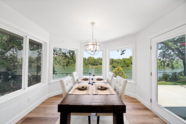 2949 Felstet Ln, Redding, CA 96001 - dining area with a chandelier, light wood-style flooring, and a water view