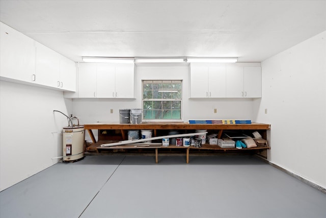 2949 Felstet Ln, Redding, CA 96001 - misc room featuring electric water heater, concrete flooring, and a workshop area