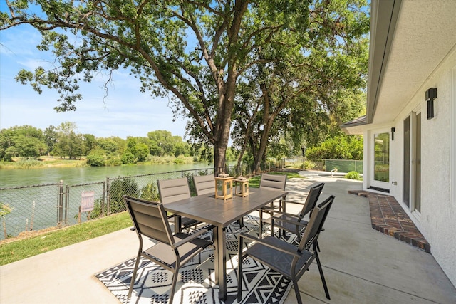 2949 Felstet Ln, Redding, CA 96001 - fenced backyard with a patio, outdoor dining area, and a water view