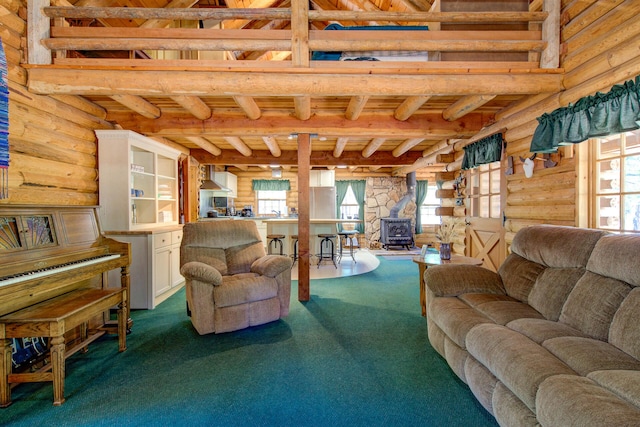 27401 Goodman Rd, Fall River Mills, CA 96028 - living room with rustic walls, carpet, a wood stove, and a wood ceiling with exposed beams