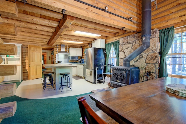 27401 Goodman Rd, Fall River Mills, CA 96028 - dining area with a wood stove and beamed ceiling