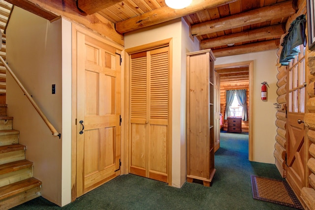 27401 Goodman Rd, Fall River Mills, CA 96028 - hall with dark carpet, a wooden ceiling with exposed beams, and stairway