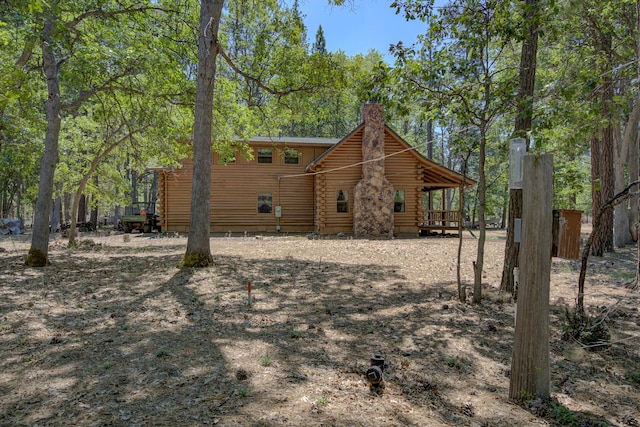 27401 Goodman Rd, Fall River Mills, CA 96028 - back of house featuring log exterior and a chimney