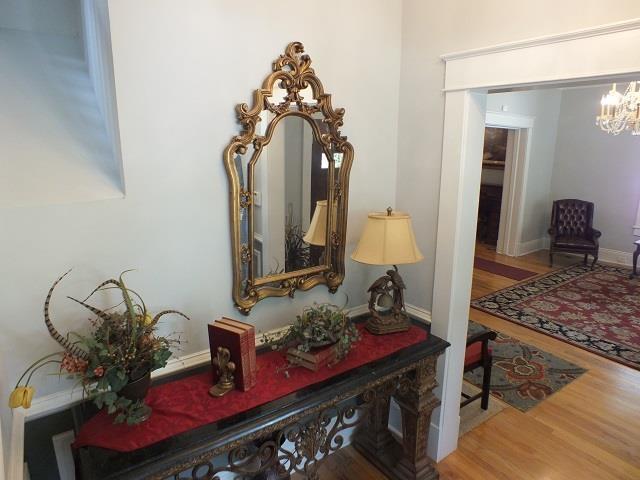 interior details with a notable chandelier and hardwood / wood-style flooring