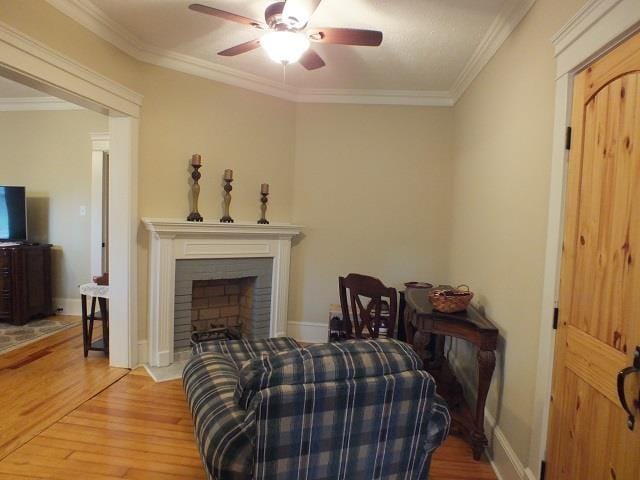 interior space with light hardwood / wood-style flooring, ceiling fan, and crown molding