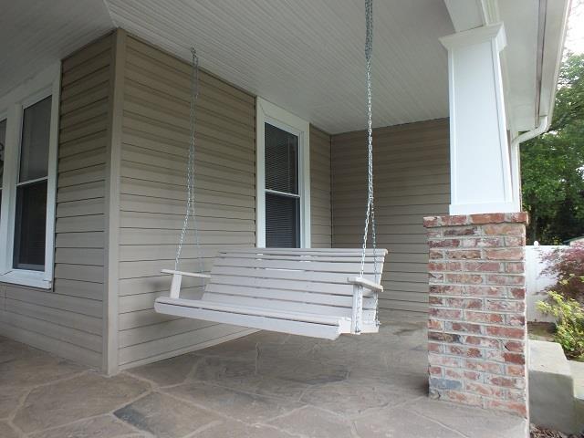 view of side of property featuring covered porch