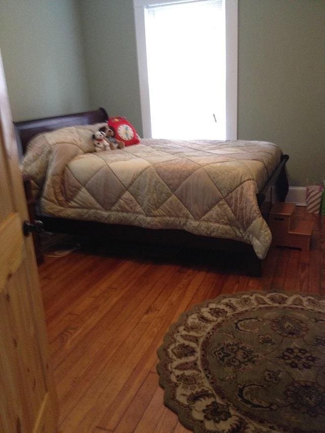 bedroom featuring dark hardwood / wood-style flooring