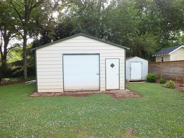 view of shed / structure with a lawn