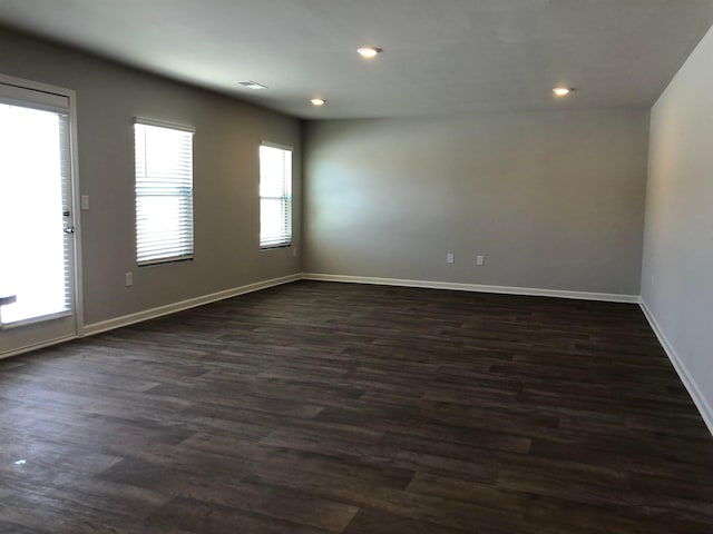 spare room with dark hardwood / wood-style flooring