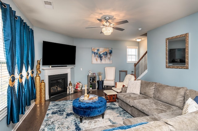 living room with dark hardwood / wood-style flooring and ceiling fan