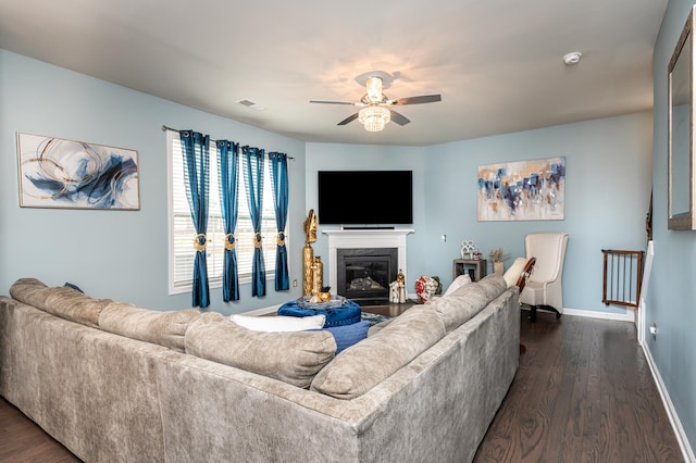 living room with ceiling fan and dark hardwood / wood-style floors