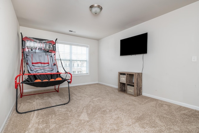 sitting room featuring light colored carpet