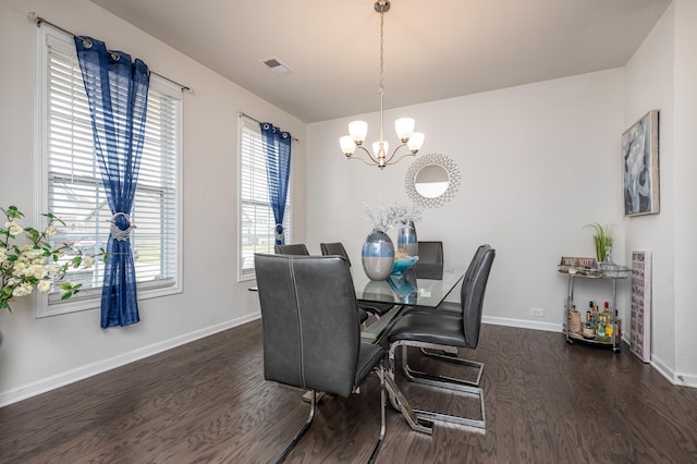 dining area with a notable chandelier and dark wood-type flooring