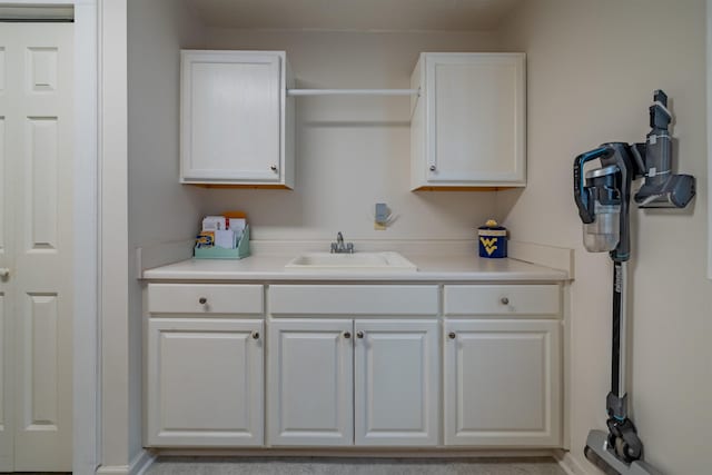 kitchen featuring white cabinetry and sink