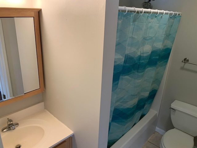 full bathroom with shower / bath combo, tile floors, toilet, and vanity