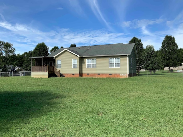 rear view of property with a yard