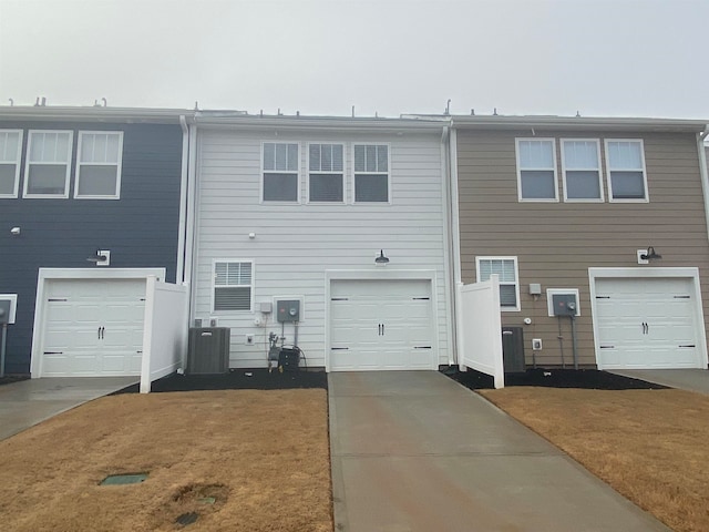 view of front of house with central AC unit and a garage