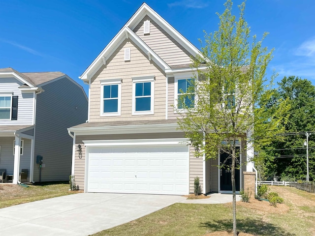 view of front of property featuring a garage and a front yard