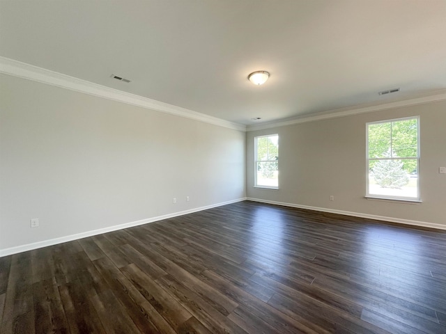 empty room featuring ornamental molding and dark hardwood / wood-style floors