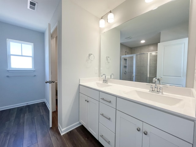 bathroom with vanity, hardwood / wood-style flooring, and walk in shower