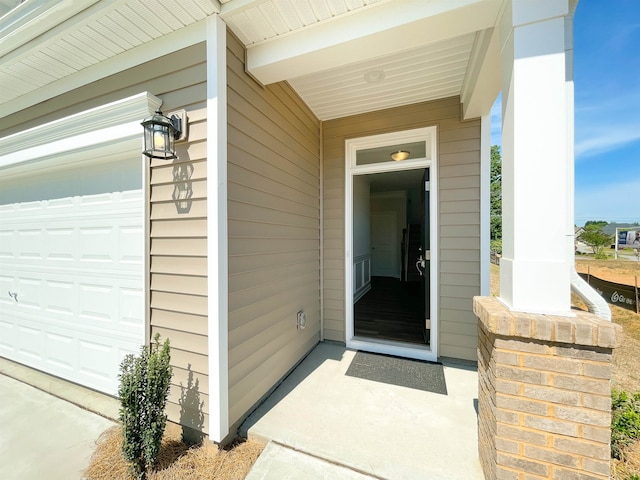 view of exterior entry with a garage