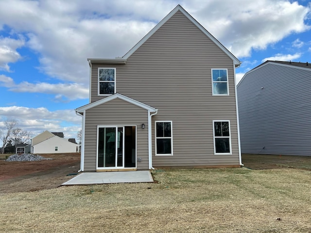 back of property featuring a lawn and a patio