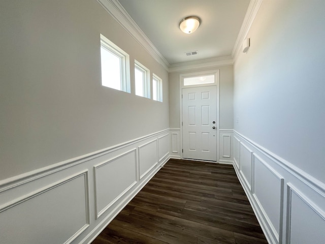 entryway with ornamental molding and dark hardwood / wood-style floors